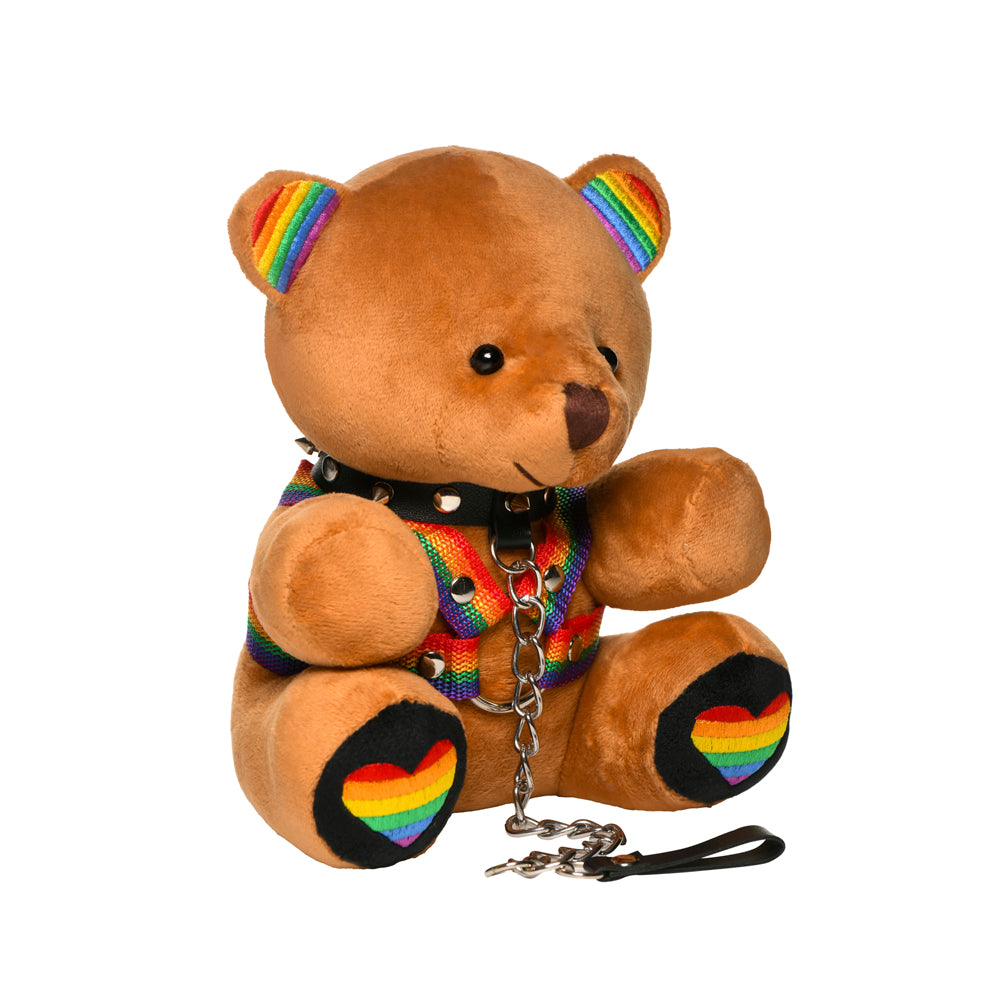 Pride teddy bear plush with rainbow accents, harness, spiked collar, and leash.