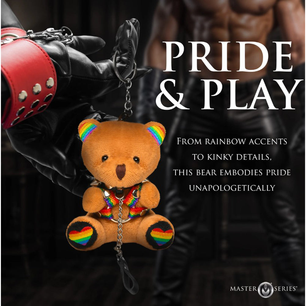 A plush teddy bear keychain with rainbow accents and a spiked collar.