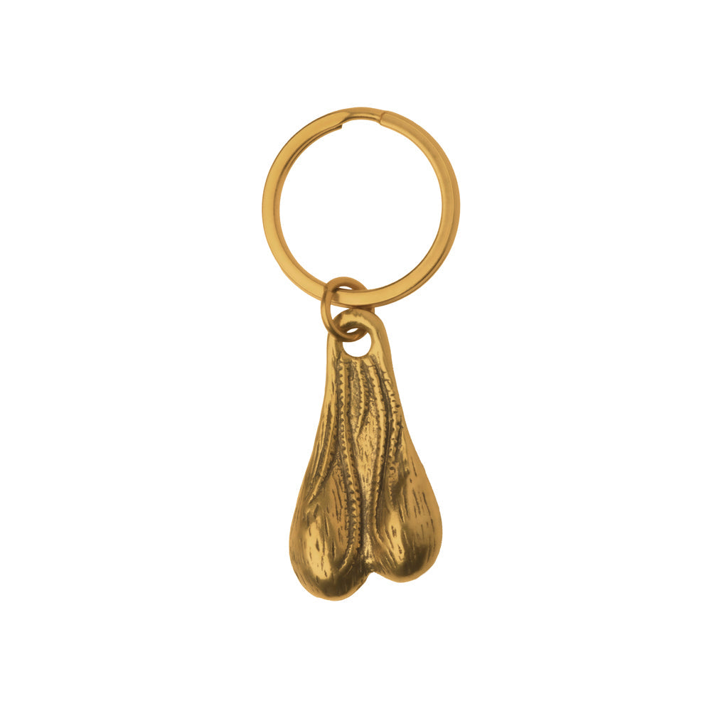 A brass keychain with a novelty nut charm.