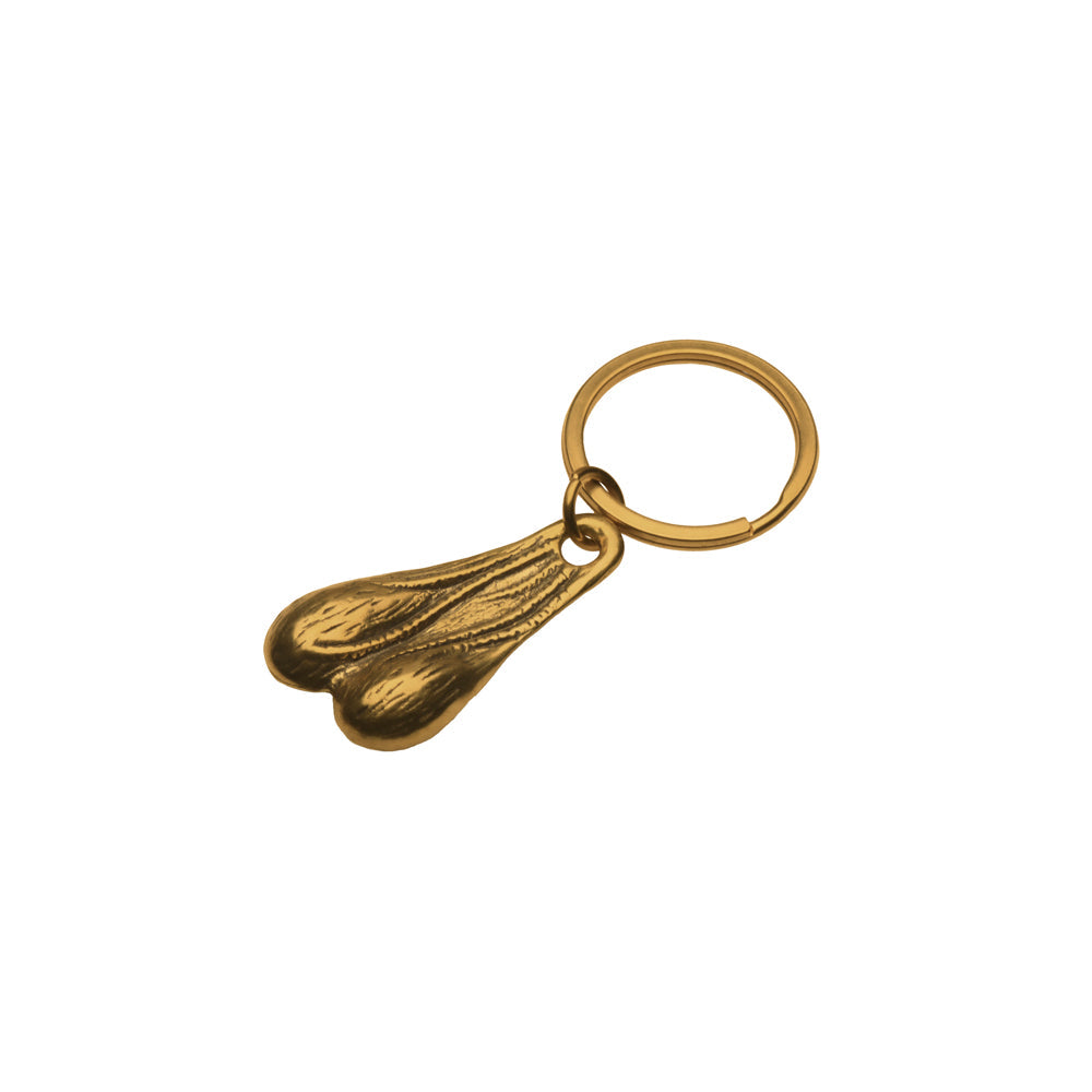 Brass novelty keychain with a pair of testicles and a metal ring.