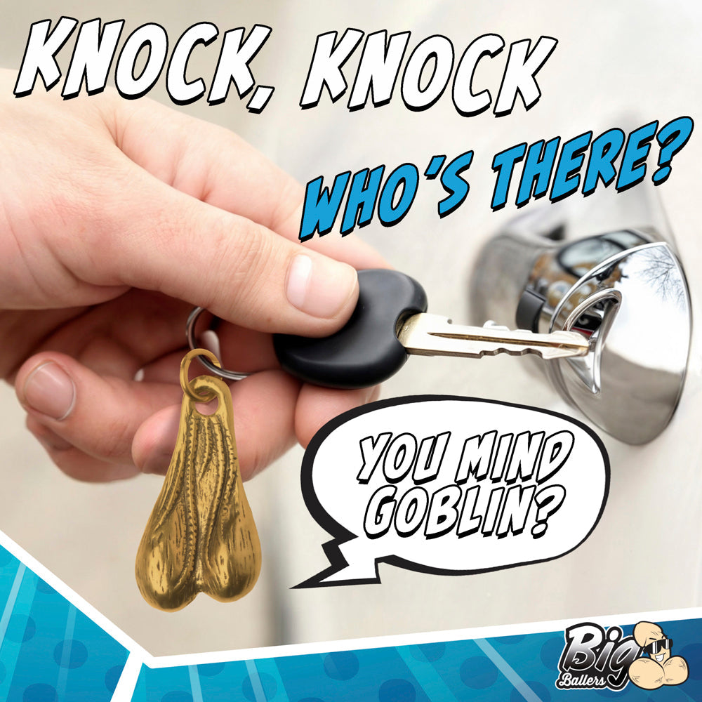 Brass novelty keychain shaped like testicles with a metal ring.