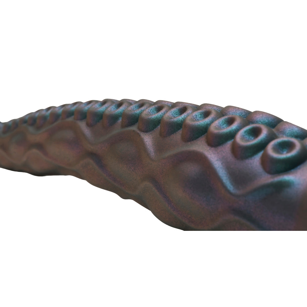 Tentacle silicone vibrator with iridescent teal color and textured suckers.