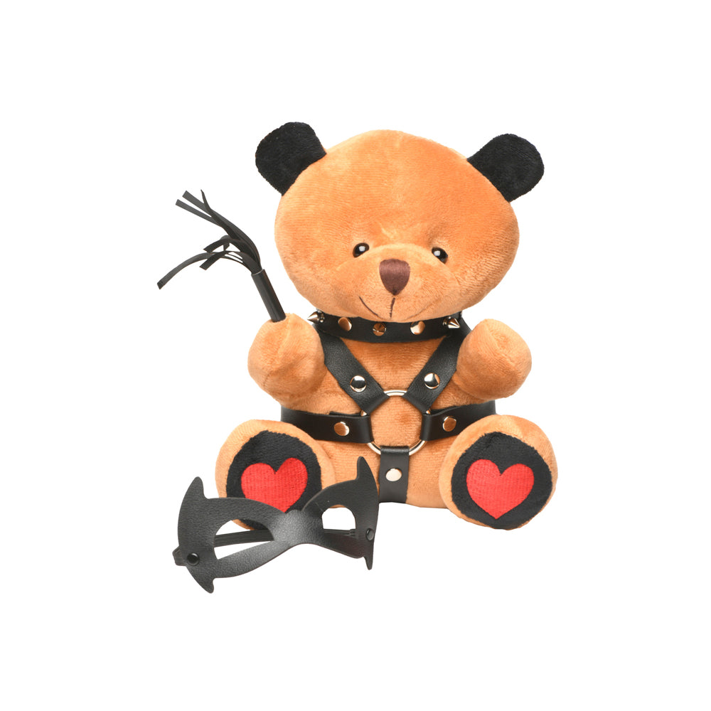 Brown teddy bear with black vegan leather collar, harness, whip, and mask.