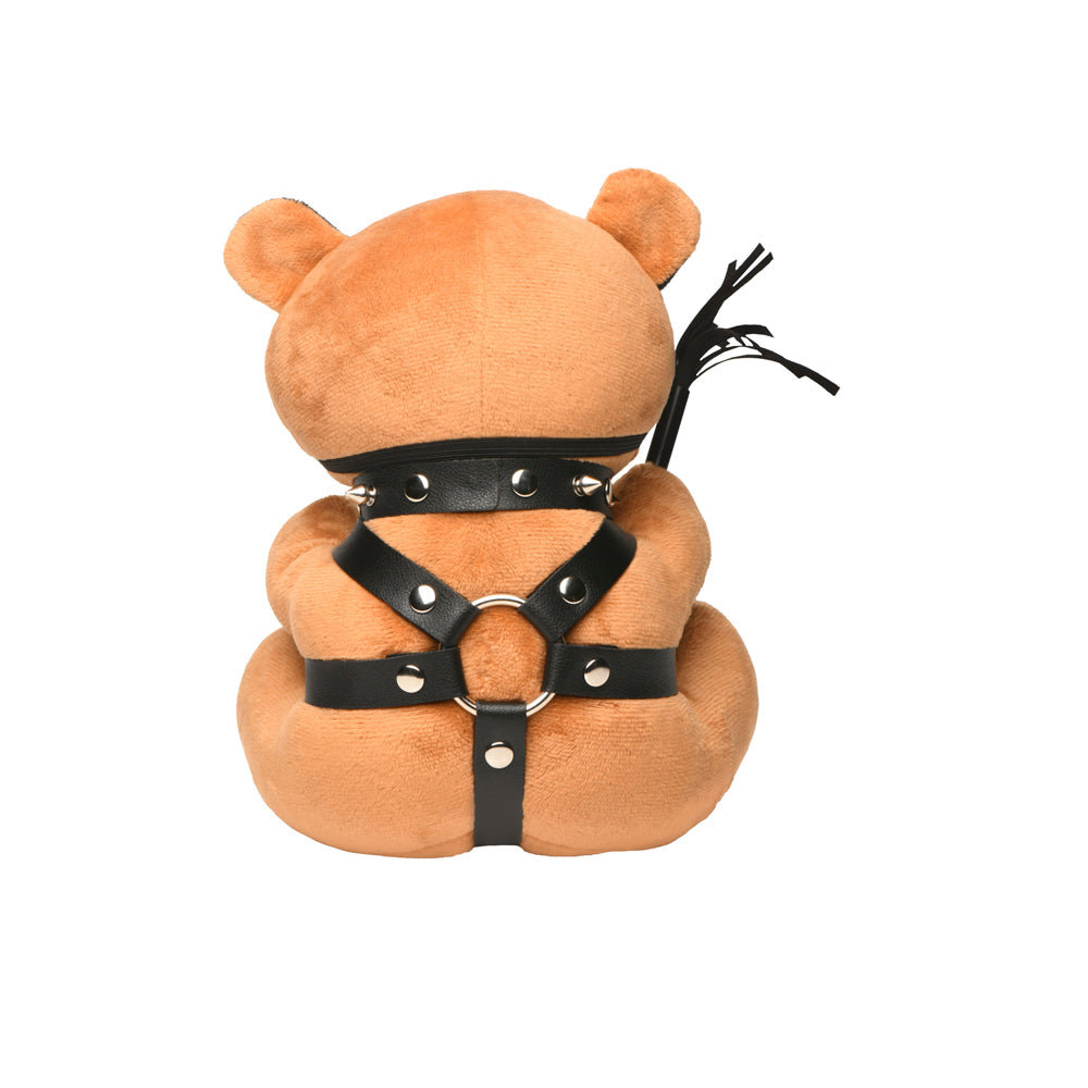 Brown teddy bear with black vegan leather harness and spiked collar.