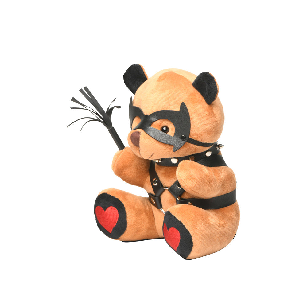 Brown teddy bear with black vegan leather mask, harness, and whip.