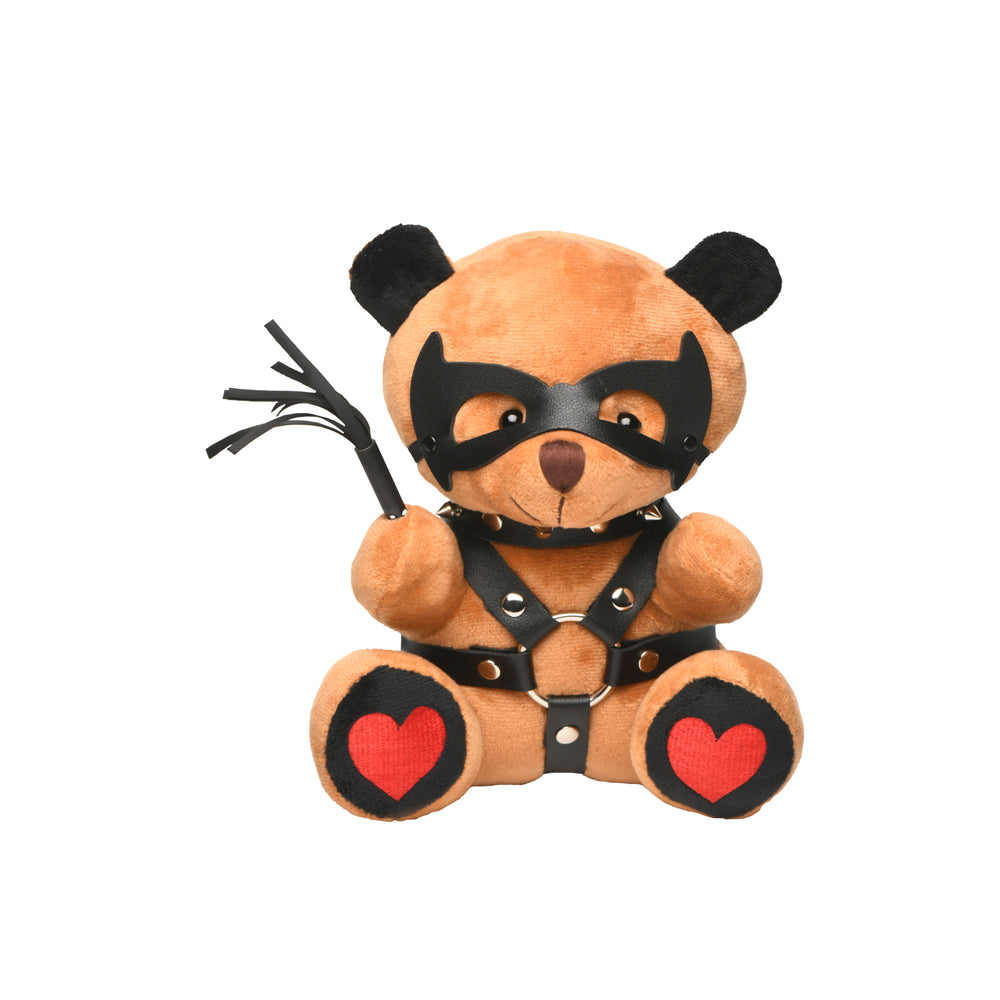 Brown teddy bear with black mask, collar, harness, and whip.