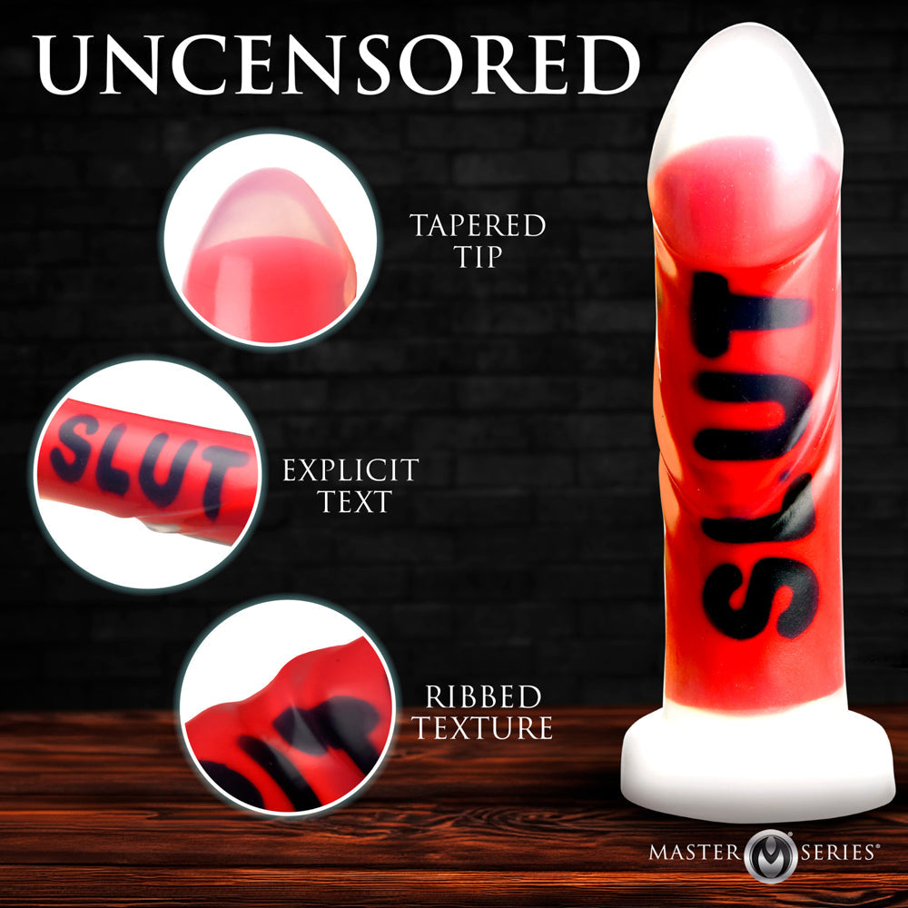 Red ribbed dildo with "SLUT" text and tapered tip.