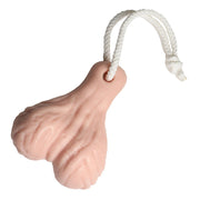 A pink, scrotum-shaped soap on a white rope.