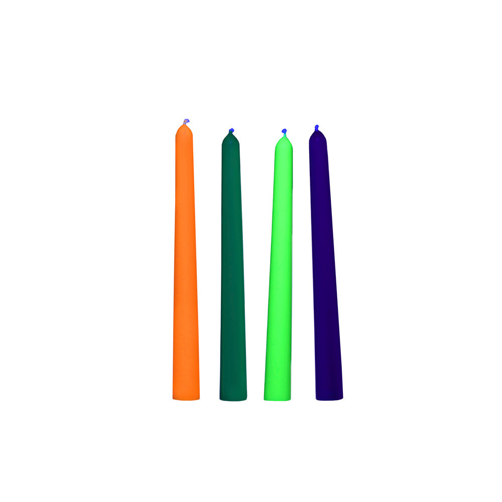 Four tall, thin taper candles in orange, dark green, lime green, and dark blue.