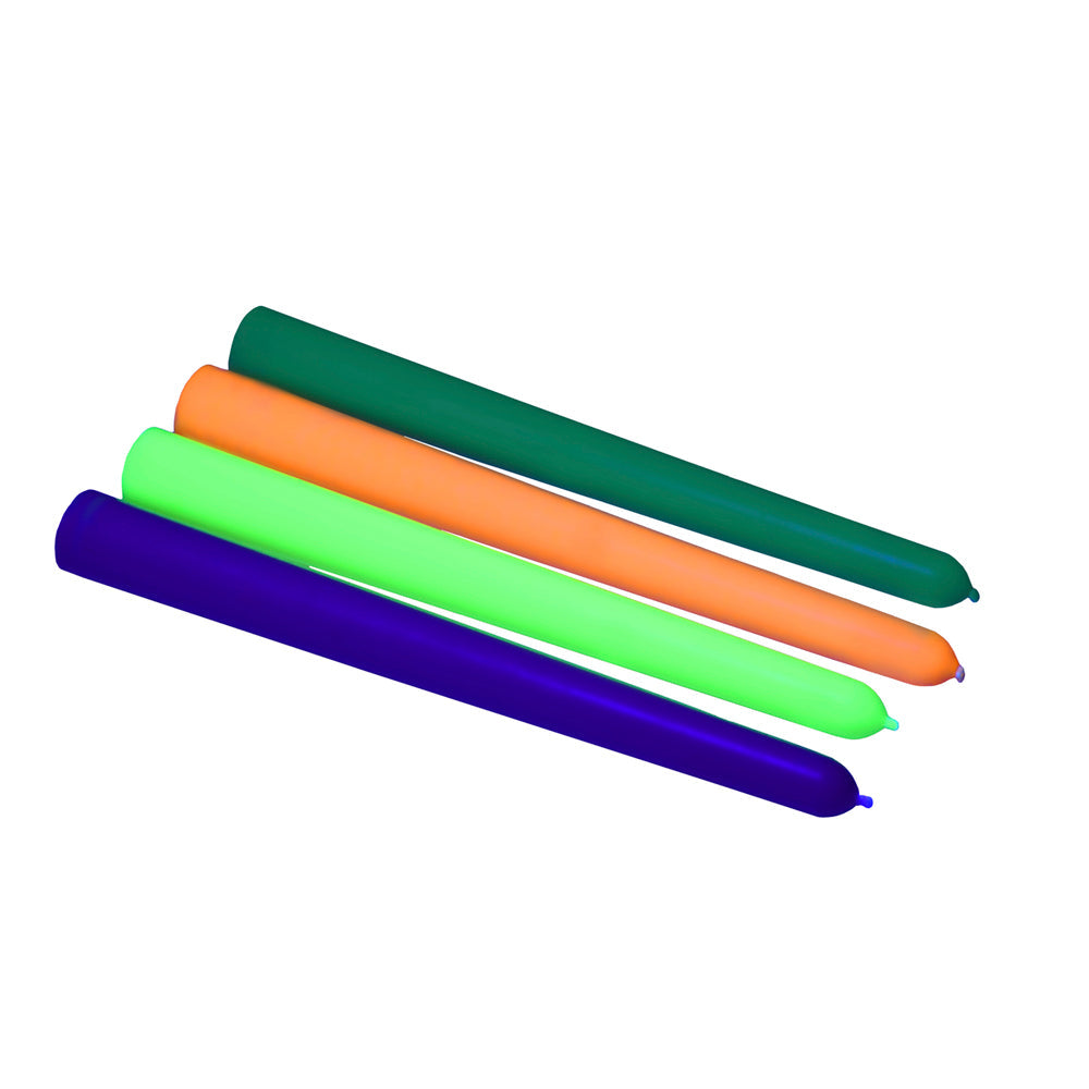 Four long, thin, unlit candles in green, orange, lime green, and purple.