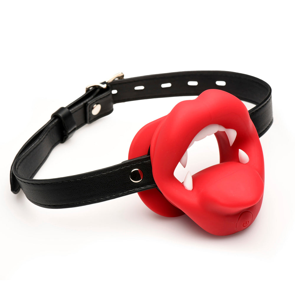 Red silicone vampire mouth gag with white fangs on a black leather strap.