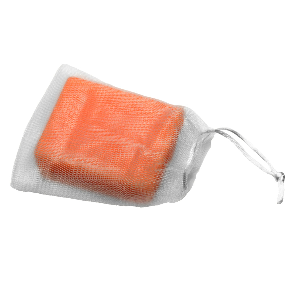 Orange bar of soap in a white mesh bag with a drawstring.