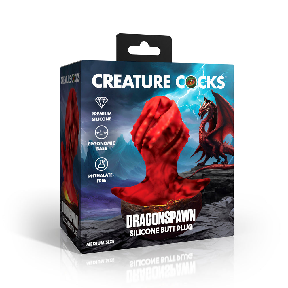 Red silicone butt plug with a dragon design on a box.