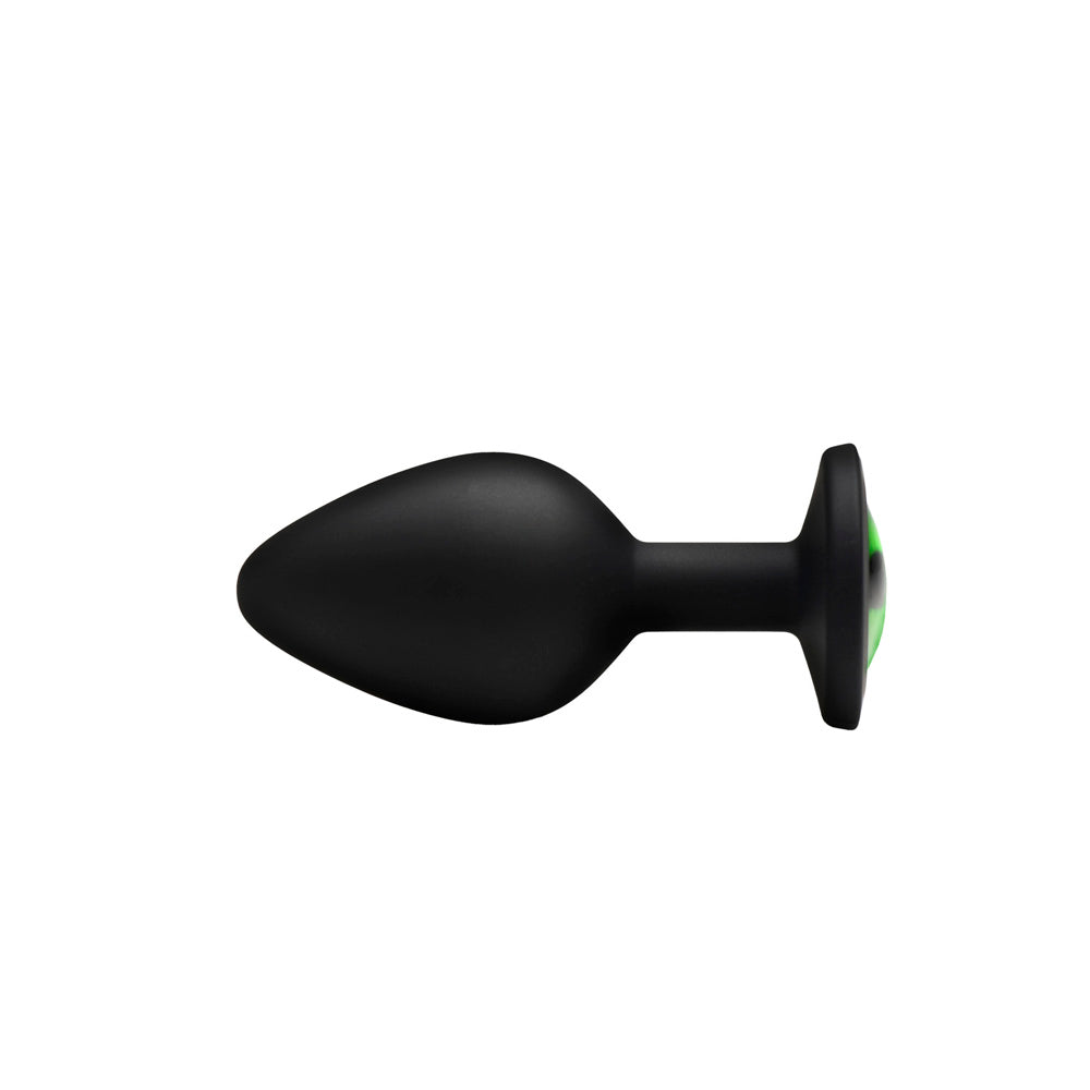 Black silicone anal plug with a green creature eye design.