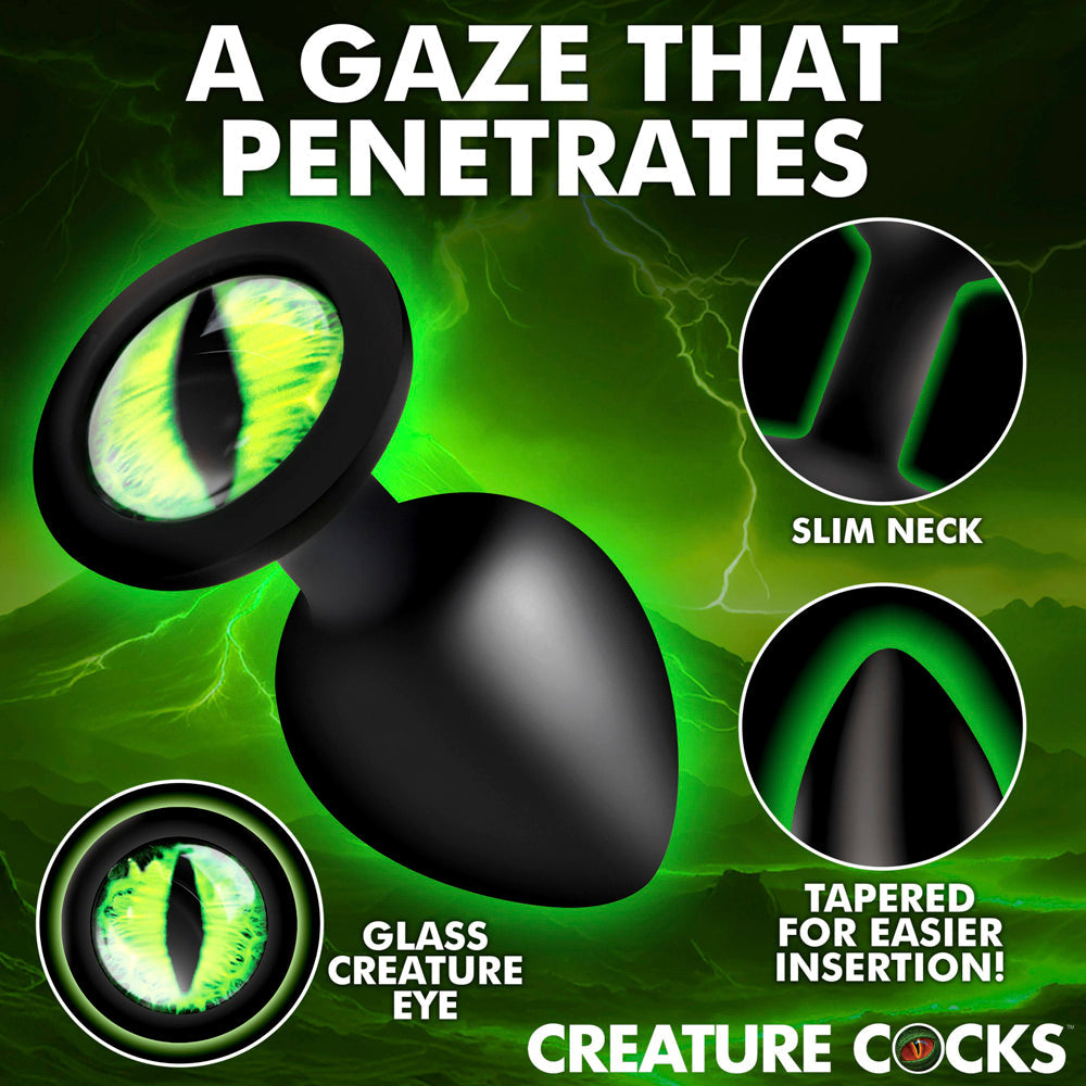Green creature eye silicone anal plug with a tapered tip and slim neck.