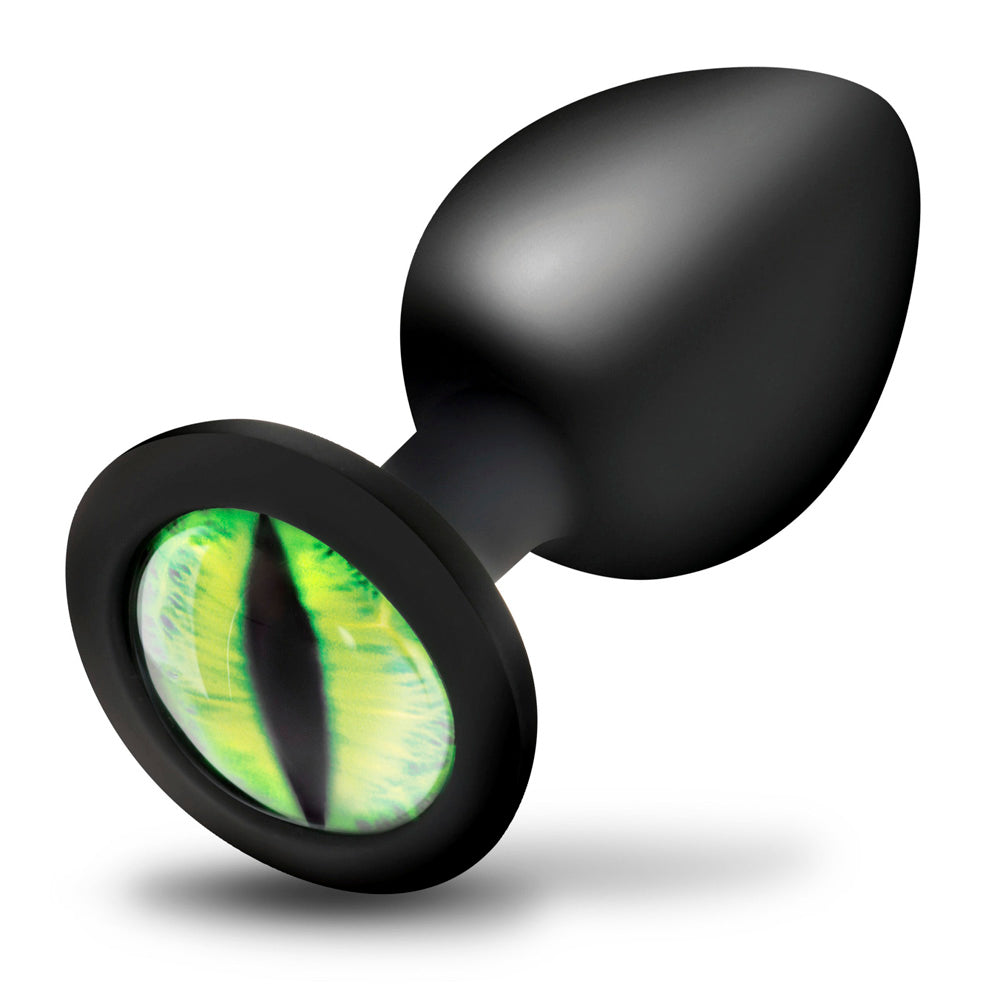 Black silicone anal plug with a green creature eye design.