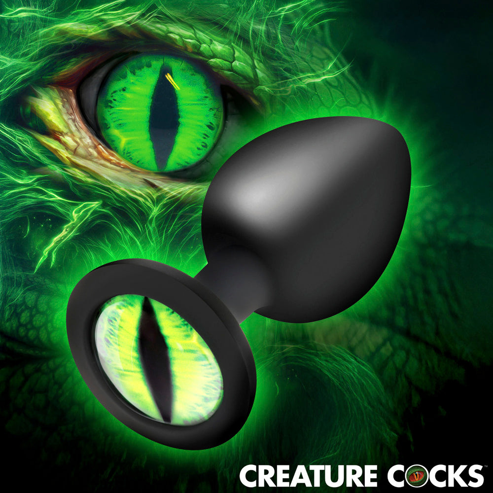 Green creature eye silicone anal plug with a tapered tip and wide base.
