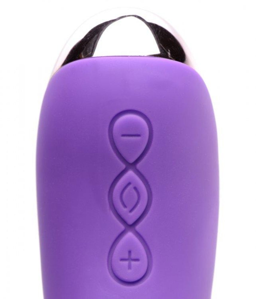 Purple silicone massager with silver top and control buttons.