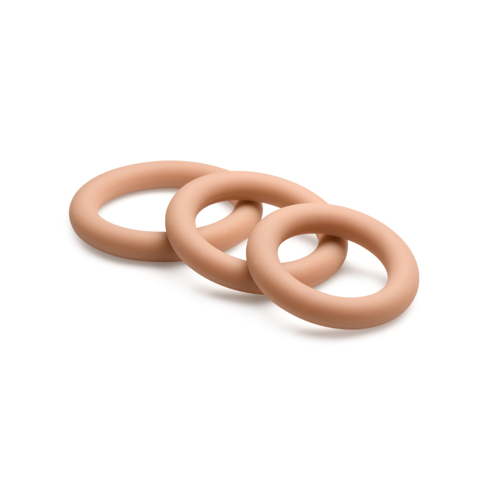 Three tan silicone cock rings in graduated sizes.