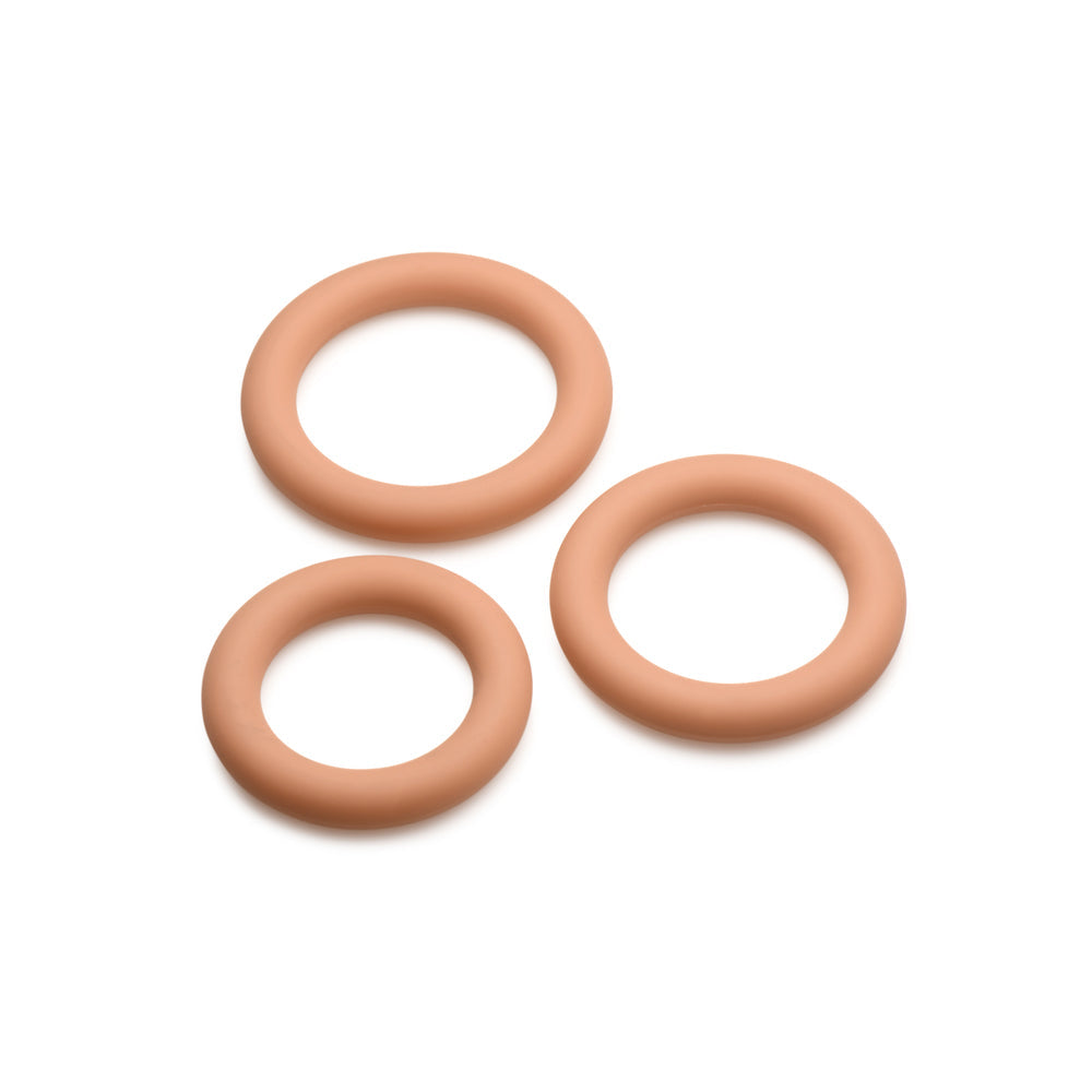 Three tan silicone cock rings in graduated sizes.