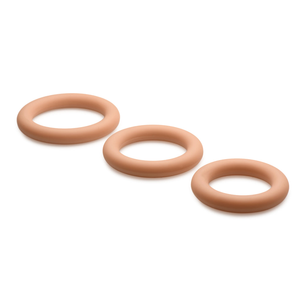 Three tan silicone cock rings in graduated sizes.