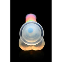 A glow-in-the-dark rainbow silicone dildo with balls.
