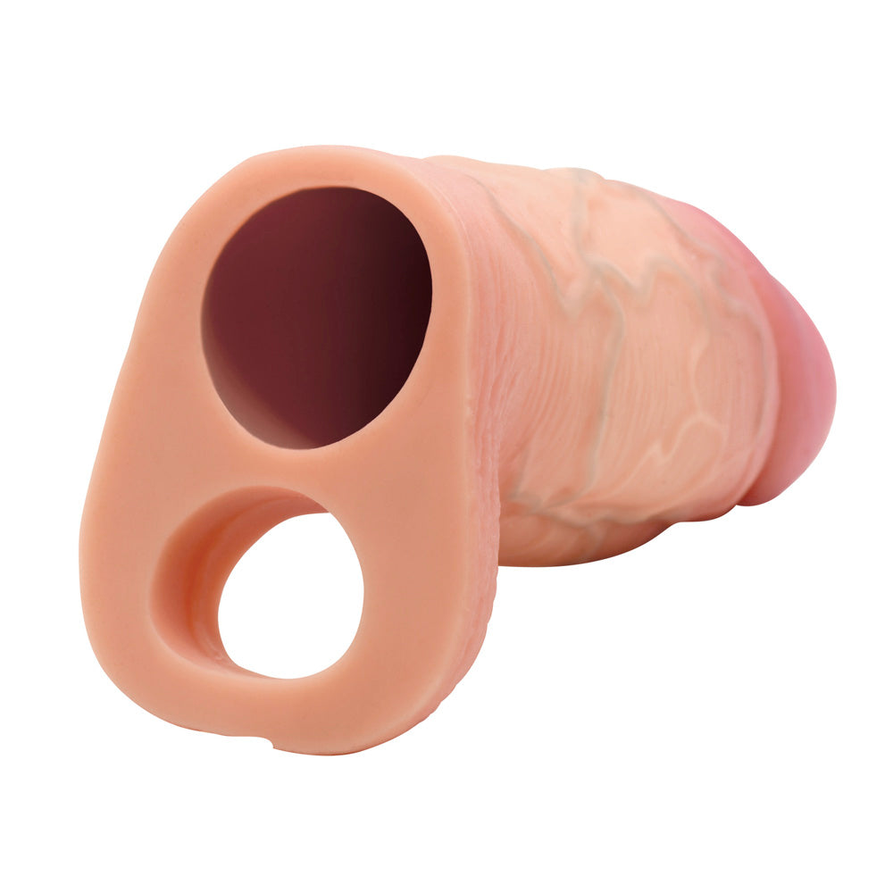 Silicone penis extension sleeve with ball strap and realistic texture.