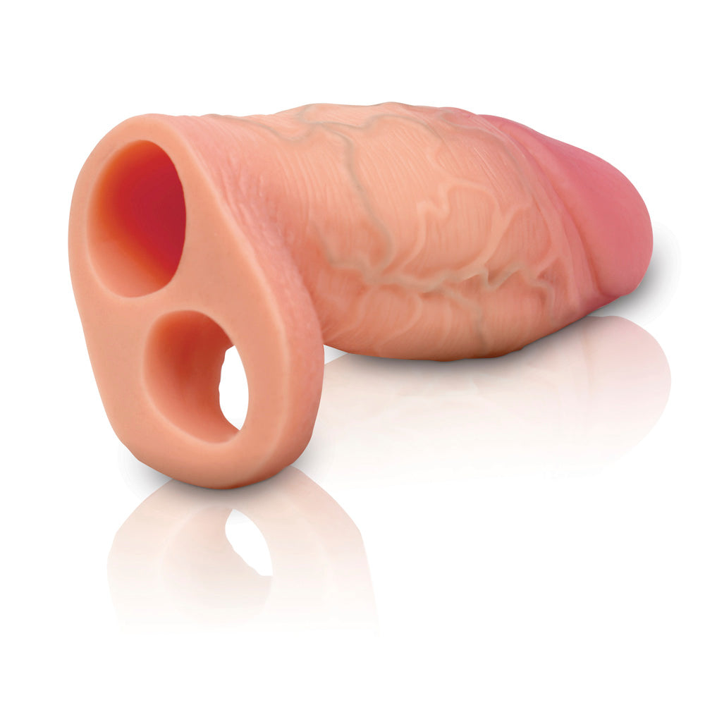 Silicone penis extension sleeve with ball strap, light pink with textured veins.