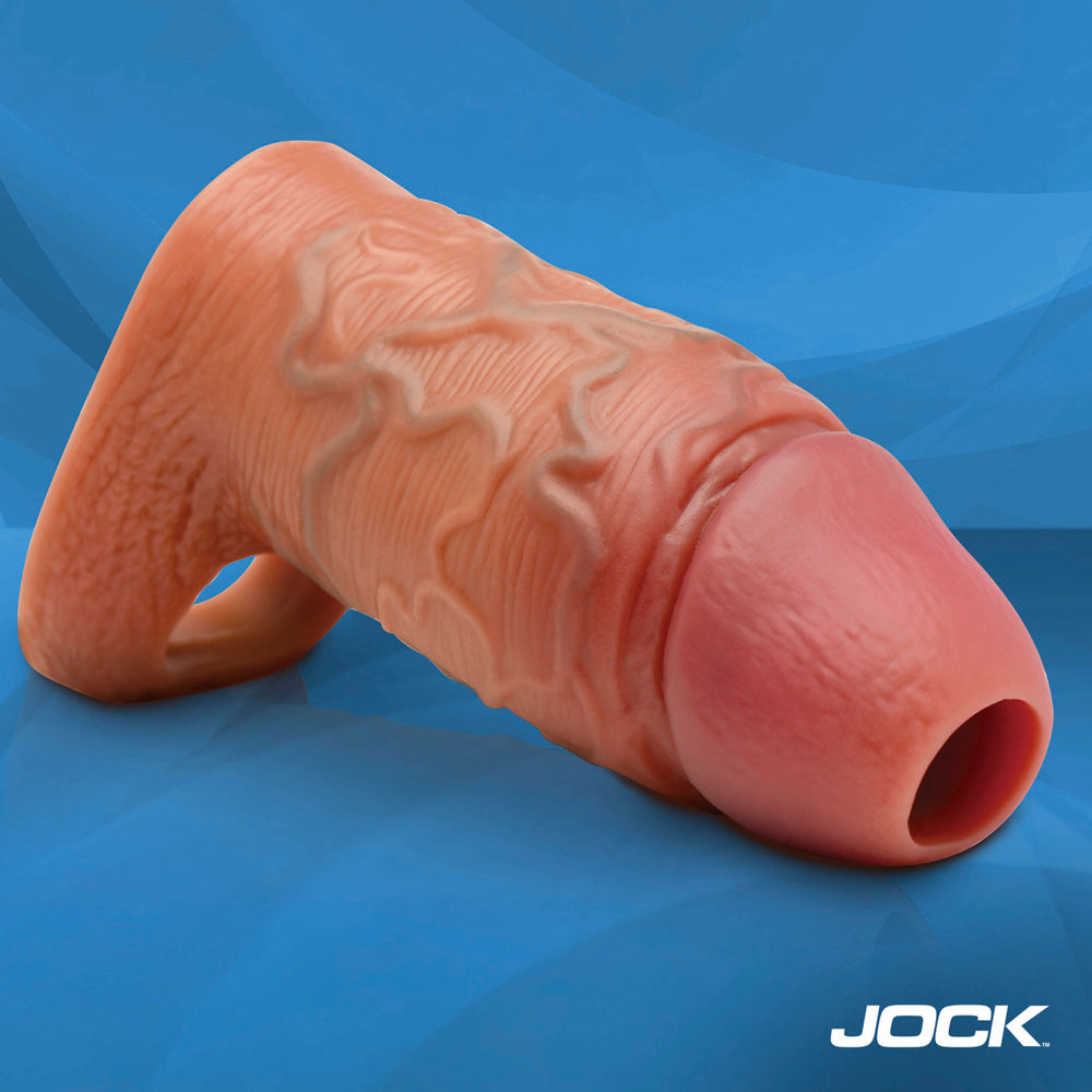 Tan silicone penis extension sleeve with ball strap and realistic veined texture.