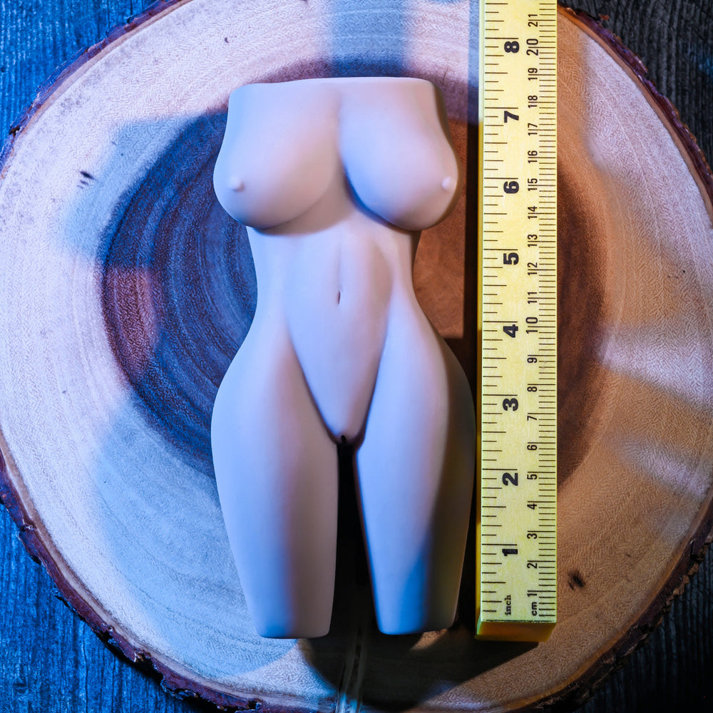 Textured body stroker with vibrating ring, 7.5 inches tall, on wooden base with ruler.