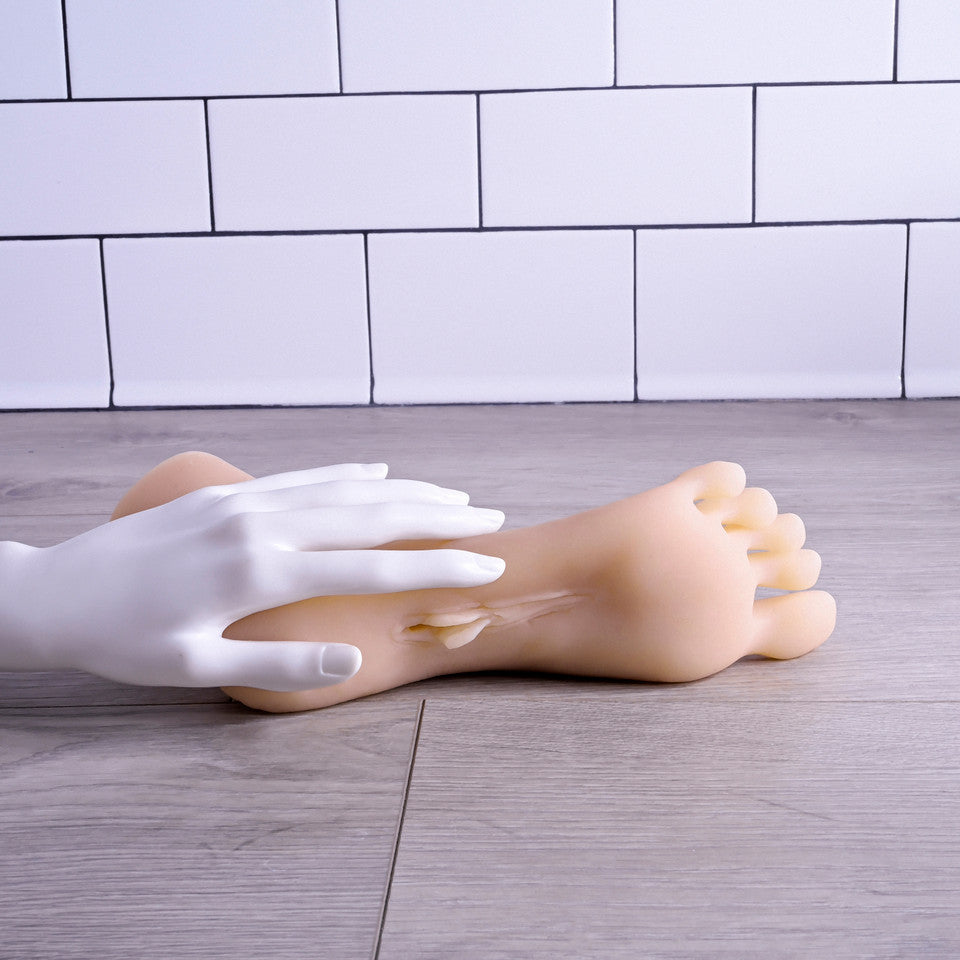 Realistic TPE foot fetish toy with lifelike toes and a discreet opening.