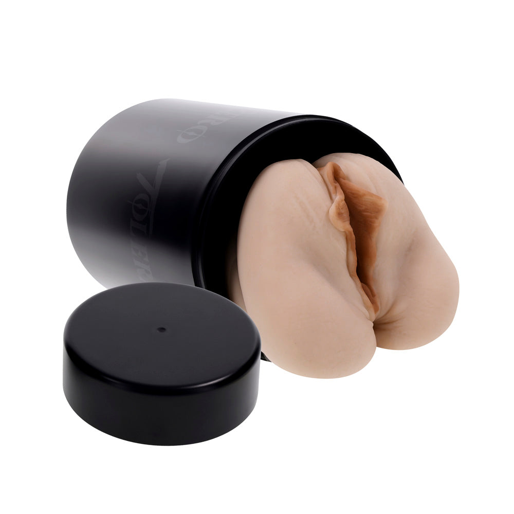 A flesh-toned dual entry stroker with a black storage canister.