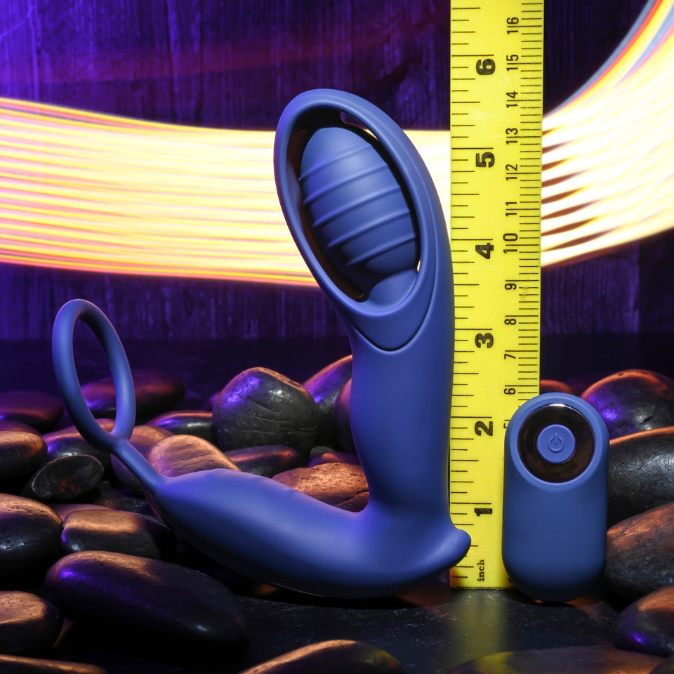 Blue double motor C-ring vibrator with remote control, next to a ruler.