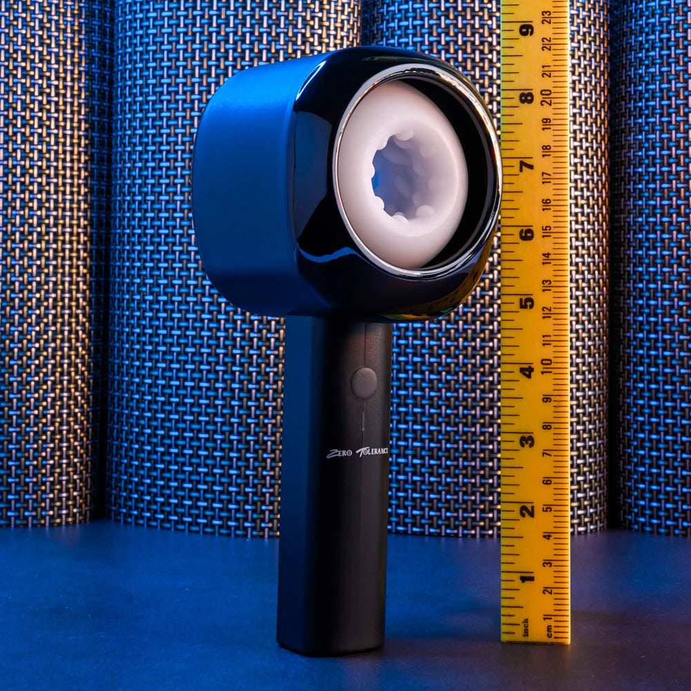 A blue and black rechargeable stroker with a textured interior, next to a ruler.