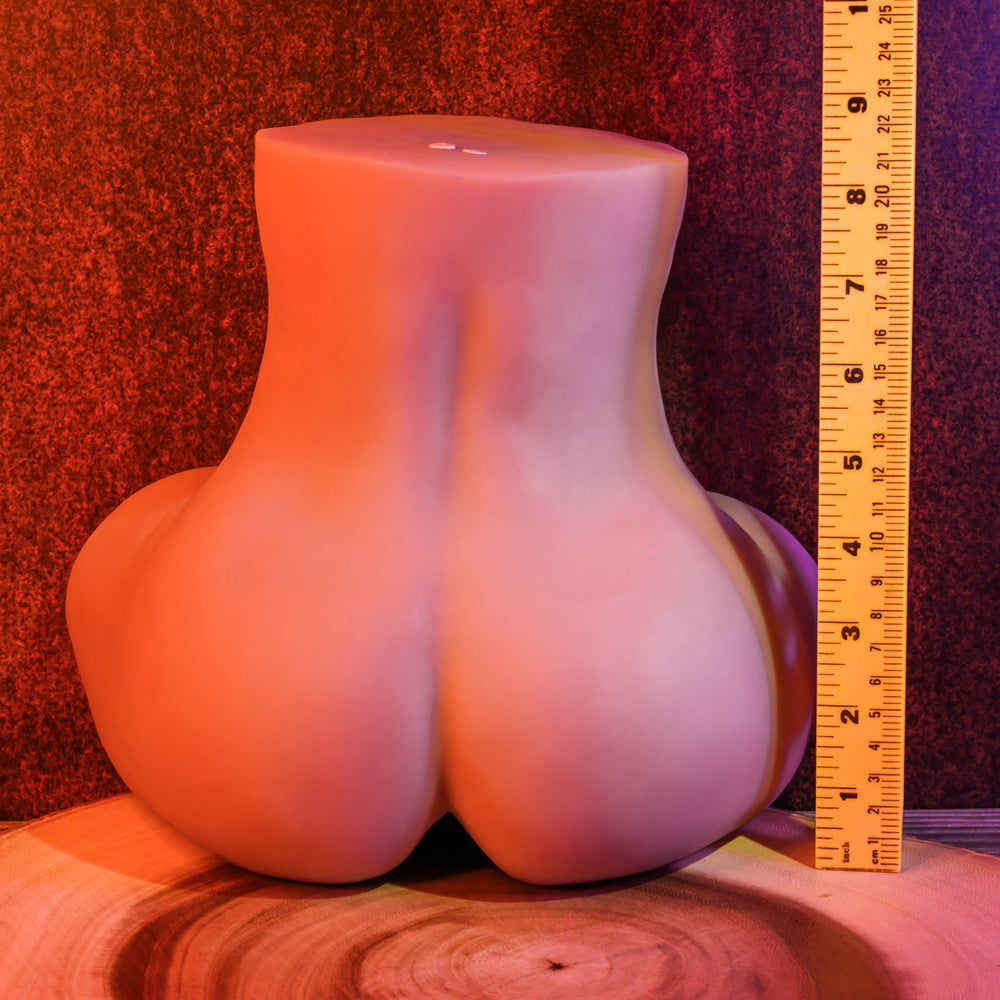 Realistic pink silicone buttocks model with dual orifices, shown from rear view.