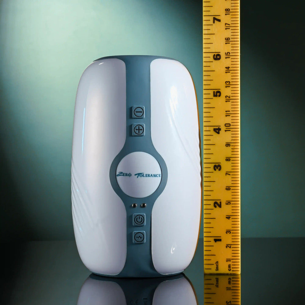 Zero Tolerance rechargeable stroker with buttons and a ruler for scale.
