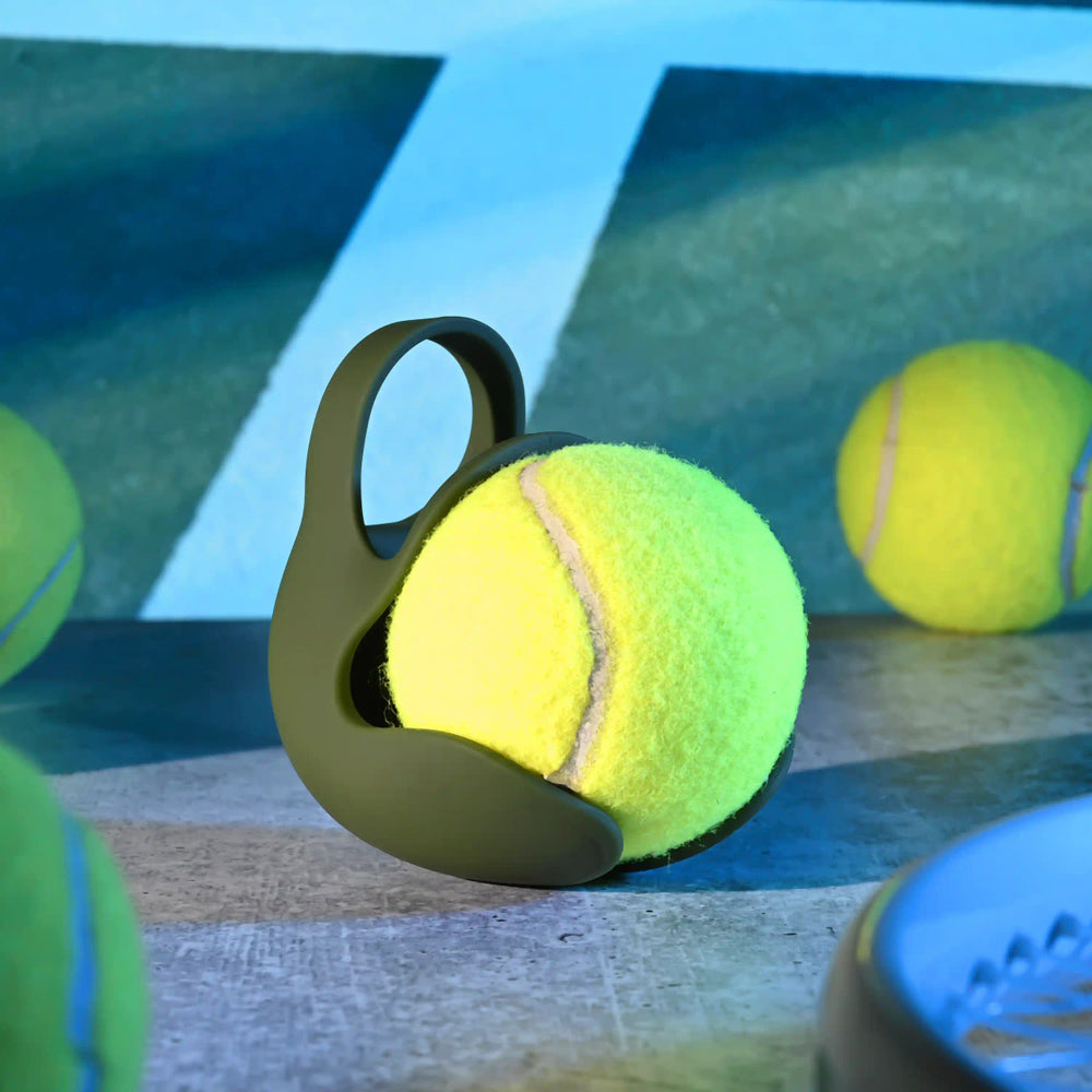 Vibrating silicone ball ring with a textured shield and handle.