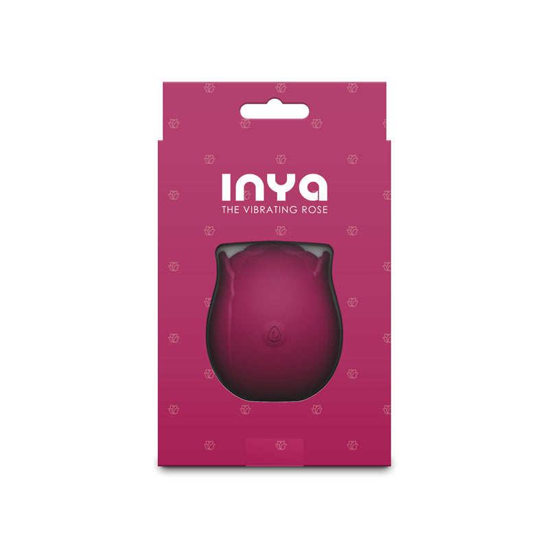 A pink vibrating rose massager in its packaging.