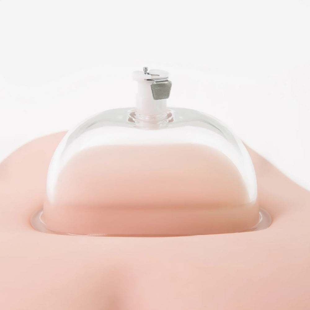 A clear acrylic cup with a pump mechanism is shown on a pink surface.