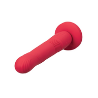 A red silicone dildo with a suction base and ribbed texture.