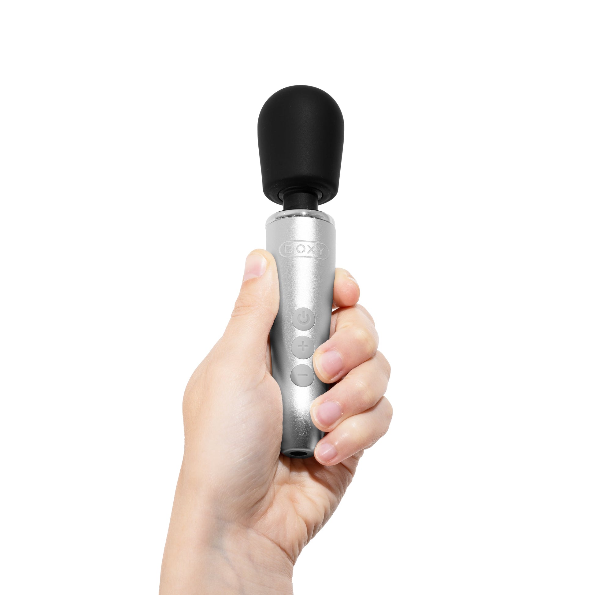 A hand holds a silver Doxy Go wand massager with a black head.