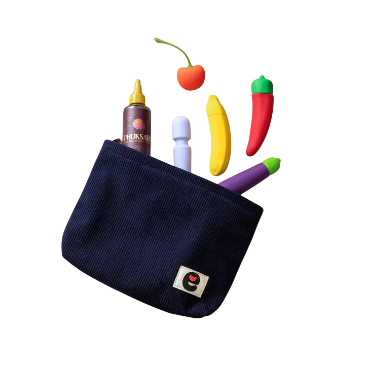 Midnight blue corduroy travel pouch with playful fruit-shaped items and a small toy.