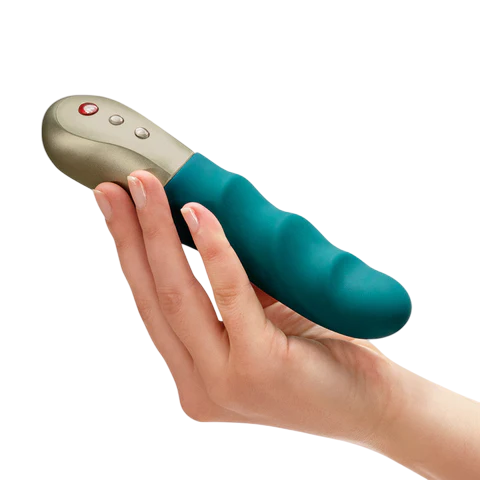 A hand holds a deep sea blue vibrator with a gold tip and buttons.