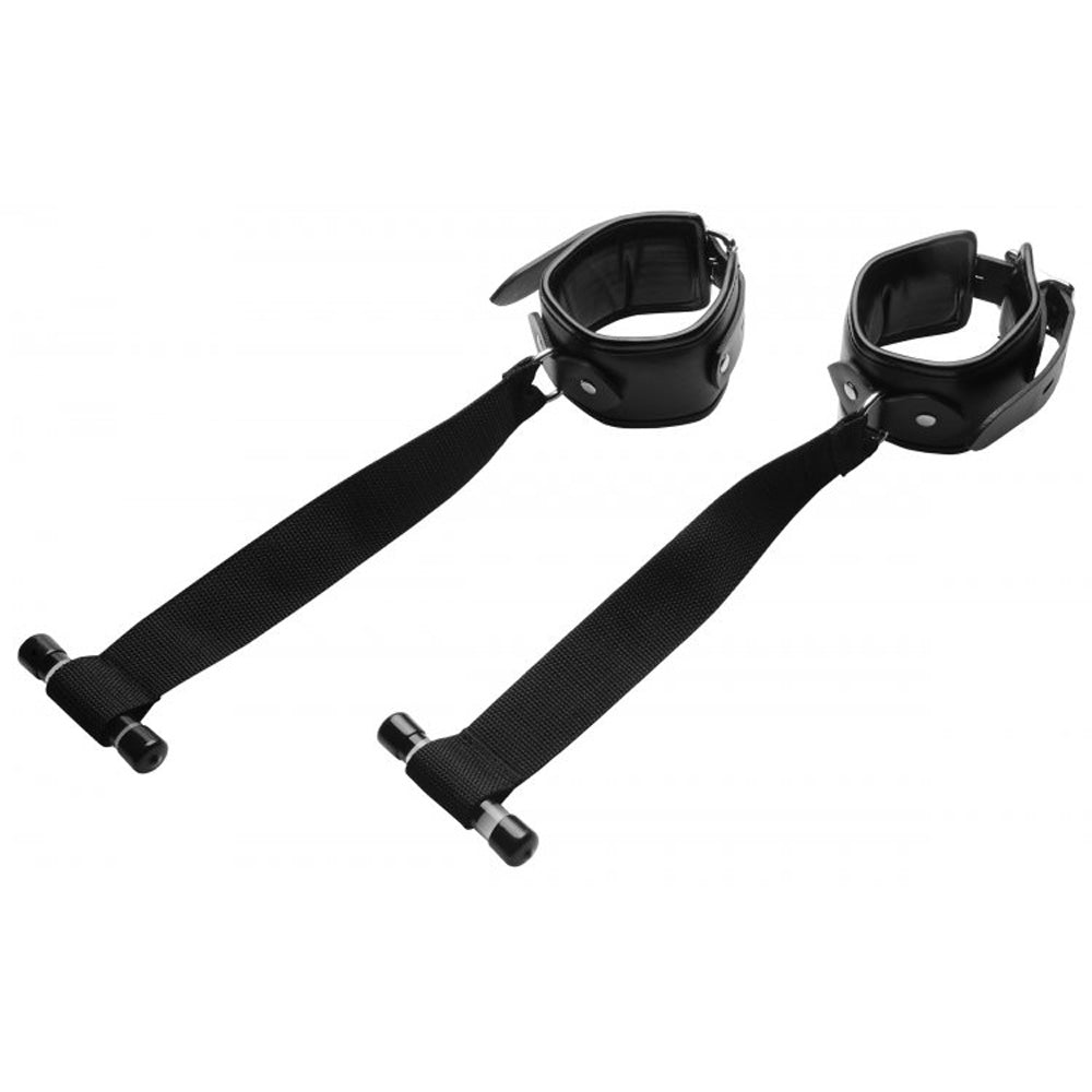 Black padded bondage restraints with adjustable straps and T-bar handles.