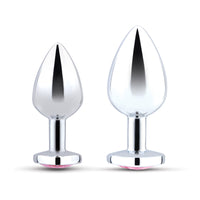 Two silver anal plugs with pink gem bases, one smaller than the other.