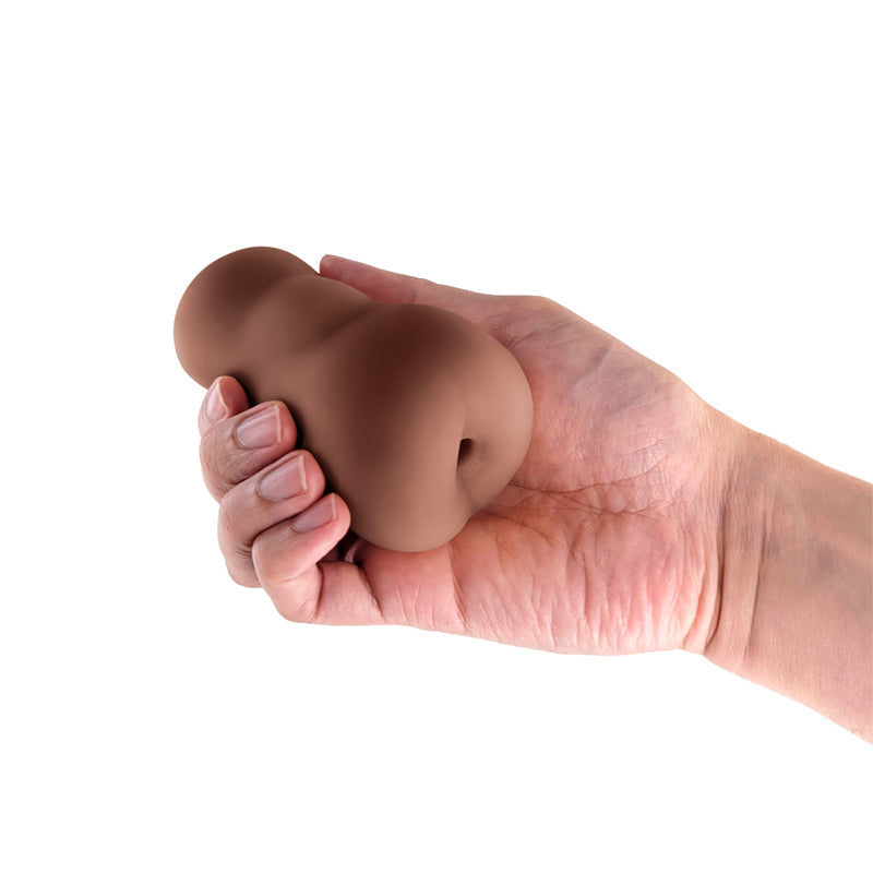 Brown TPE anal stroker held in a hand.