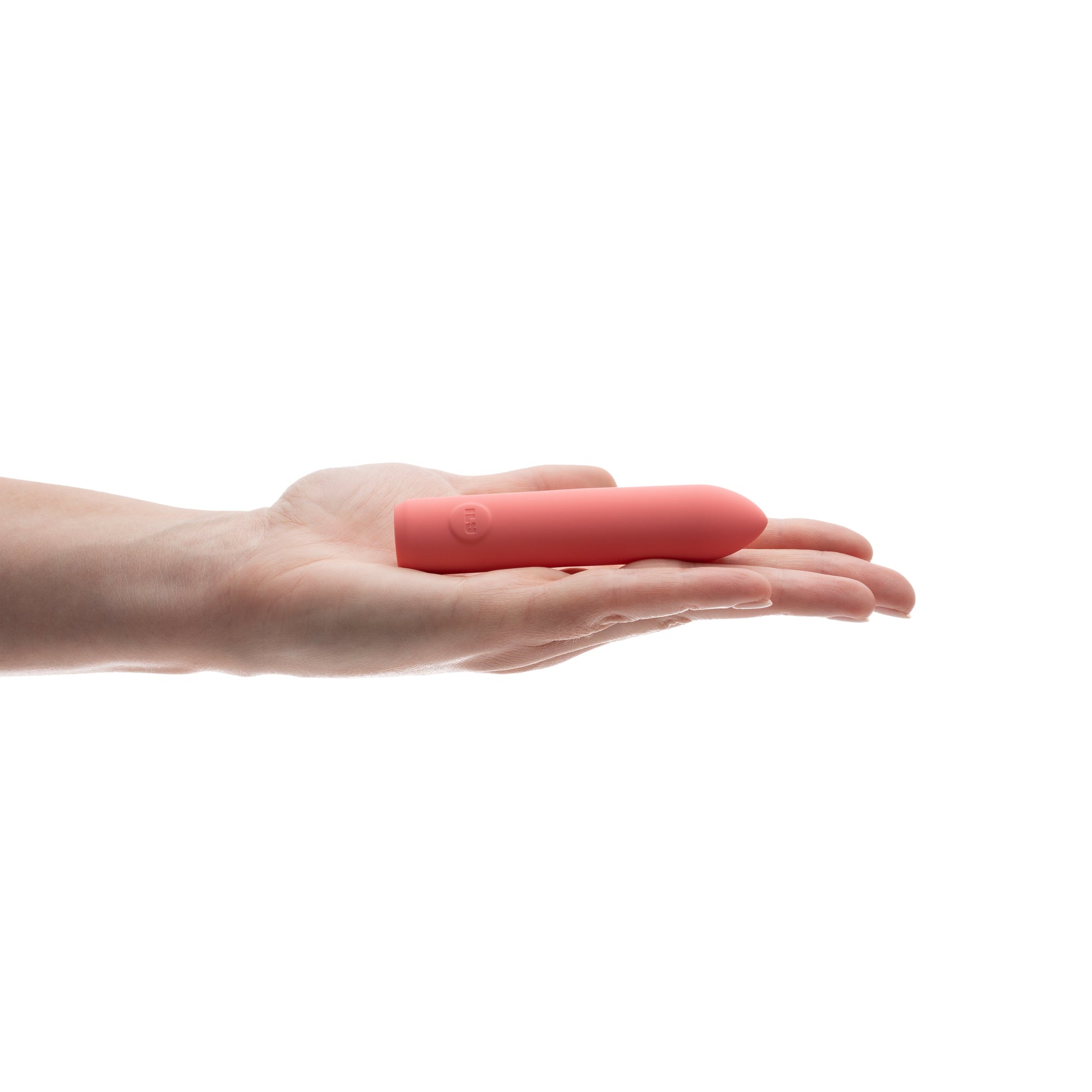 A pink rechargeable vibrator rests in an open palm.