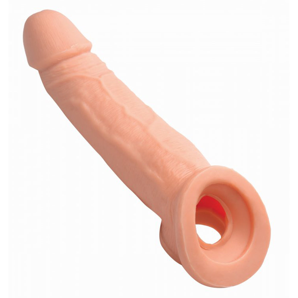 Pink realistic penis extension sleeve with solid tip and scrotum strap.