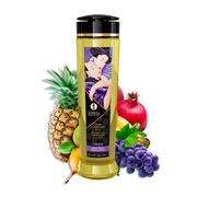 Shunga massage oil bottle surrounded by exotic fruits.