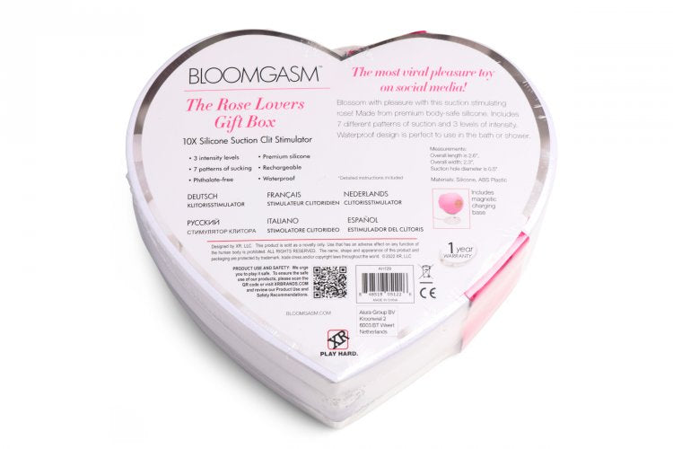 Heart-shaped gift box with a pink silicone rose toy and faux roses.